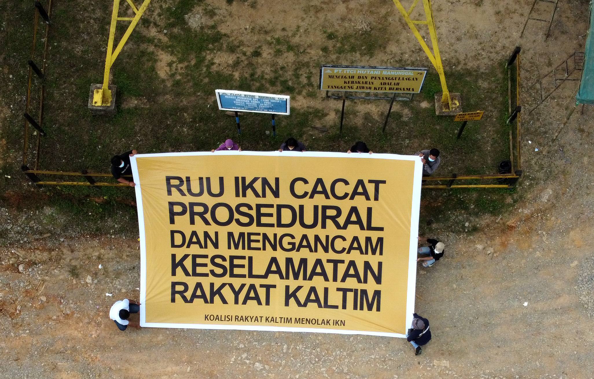 Aktivis yang tergabung dalam gerakan #BersihkanIndonesia membentang spanduk menolak proyek pembangunan ibu kota negara baru di areal hutan tanaman industri yang rencananya akan menjadi pusat pembangunan IKN Nusantara di Kaltim. (Jatam Kaltim) 