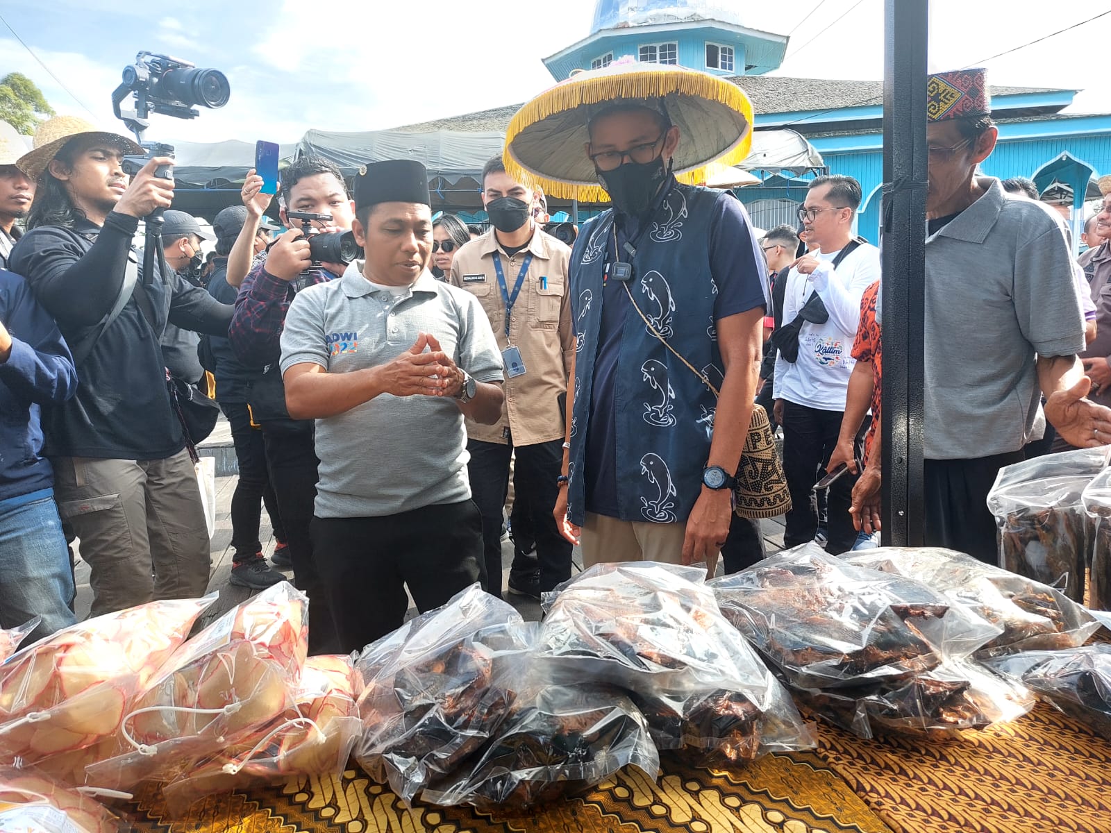 Ketua Pokdarwis Desa Pela, Alimin (peci hitam) saat menjelaskan hasil UMKM masyarakat kepada Menparekraf Sandiaga Uno. (Supri/Kaltimtoday.co).